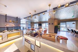 a large room with a kitchen and a dining room at Atour Hotel Rizhao Dongyi Town in Rizhao