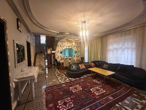 a living room with a couch and a table at Villa lux in Qusar