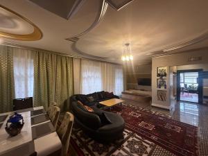a living room with a couch and a table at Villa lux in Qusar