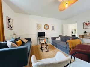 a living room with two blue couches and a tv at Casa Douce Angevine in Angers