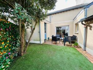 a yard with chairs and a table in a house at Casa Douce Angevine in Angers +32 photos