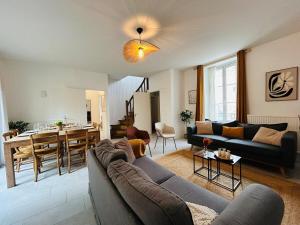 a living room with a couch and a dining room at Casa Douce Angevine in Angers