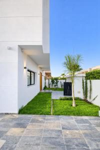 a courtyard of a house with a palm tree at Villa panorama Marrakech in Marrakesh