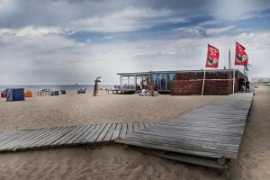 a building on the beach next to the ocean at VRS - Low Cost Beach Boat in Leça da Palmeira