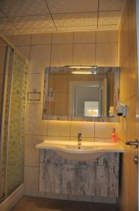 a bathroom with a sink and a mirror at Nur Hotel in Kaş