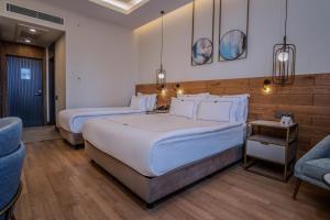 a hotel room with two beds and a couch at Miramare Beach Hotel - Ultra All Inclusive in Side