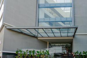 a glass walkway on the side of a building at Hotel Sky International in Kizhake Chālakudi