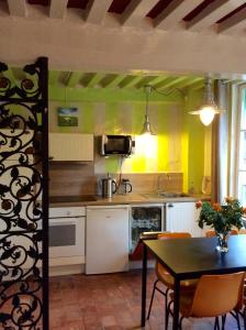 a kitchen with a table and a dining room at Appartement Le Notre Dame in Honfleur