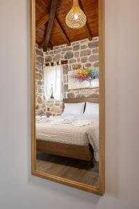 a mirror reflection of a bed in a room at Elevi Aria in Tyros
