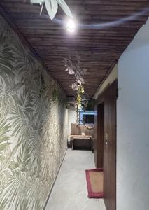 a hallway with a wall mural of plants at Hotel Classic in Pānīpat