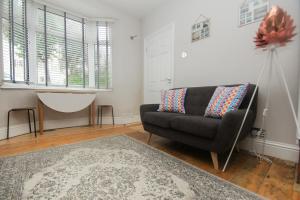 a living room with a couch and a rug at Brighton Abode - by Brighton Holiday Lets in Brighton & Hove