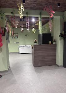 a lobby with flowers hanging from the ceiling at Hotel Classic in Pānīpat