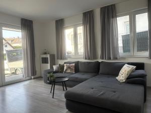 a living room with a couch and a table at Sauerland Wellness Apartment mit Sauna und Jacuzzi in Olpe