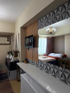 a bedroom with a large mirror and a bed at Avida Aspira Tower 1 - Chads Unit 8th Floor in Cagayan de Oro