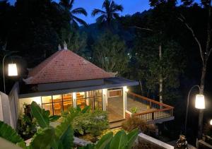 a house in the middle of a forest at night at Nadira BnB in Munduk