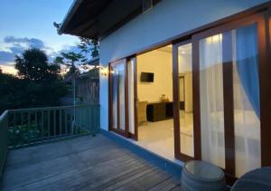 a balcony of a house with sliding glass doors at Nadira BnB in Munduk +14 photos