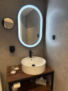 a bathroom with a sink and a mirror at Laholms Stadshotell in Laholm