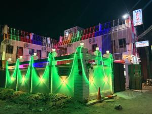 a building with christmas lights on the side of it at Gravity Groups VVJ - Near Jipmer Sangamithra in Pondicherry