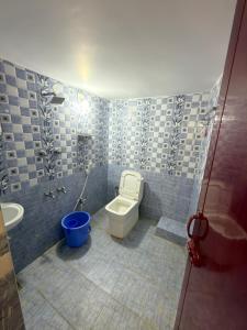 a bathroom with a toilet and a sink and a tub at Gravity Groups VVJ - Near Jipmer Sangamithra in Pondicherry