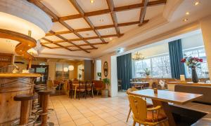 a dining room with a table and chairs at Hotel Pinzgauerhof by Alpeffect Hotels in Zell am See