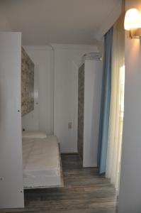 a small room with a bed and a window at Nur Hotel in Kaş