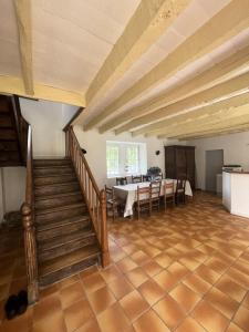 a large room with a table and chairs and stairs at Résidence 740-pleneuf Val Andre - Belle maison en pierre offrant de beaux volumes à 2km dans la de Pleneuf Val André MAE-8554 in Pléneuf-Val-André