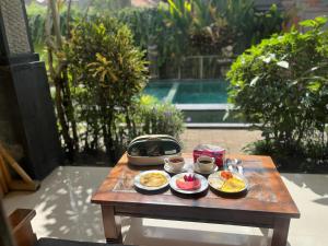 a tray of food on a table on a patio at Ariartha homestay in Ubud