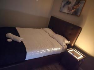a bed in a room with at Cozy 2 Bedroom basement Suite in Calgary
