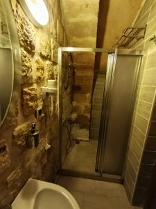 a bathroom with a shower and a toilet and a sink at Babussor konağı hotel in Eskiömerler +31 photos