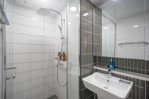 a white bathroom with a sink and a shower at Daegu lily Residence Hotel in Daegu +113 photos