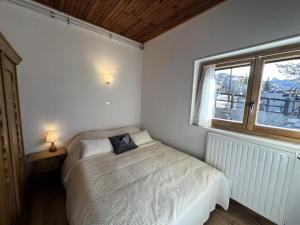 a small bedroom with a bed and a window at Chalet Le Chatelret - LE CHATELRET MAE-9361 in Vars +20 photos