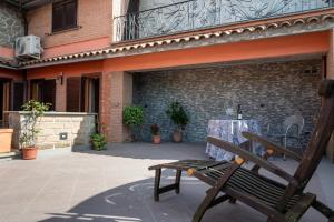 a wooden bench sitting in front of a building at Tuscia Holidays in Zepponami +5 photos