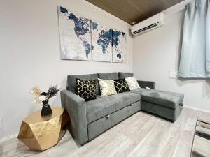 a living room with a couch and a table at Sky Terrace Kawaguchi in Kawaguchi