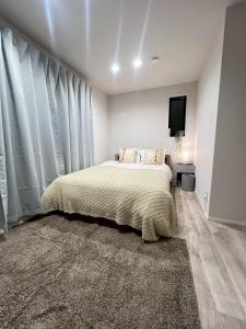 a bedroom with a bed and a large window at Sky Terrace Kawaguchi in Kawaguchi