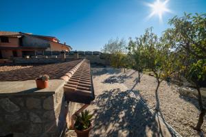 a bench on the side of a house with the sun at Tuscia Holidays in Zepponami