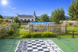 a chess board in a yard with a fence at Villa Las Catedrales - Piscina Privada - Frente a la playa - Amplio jardín in Barreiros