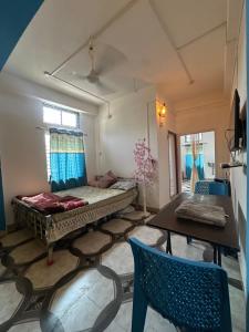 a room with a bed and a table and chairs at Green leaf homes in North Lakhimpur