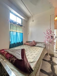 a large bed in a room with a window at Green leaf homes in North Lakhimpur