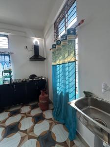 a bathroom with a sink and a shower curtain at Green leaf homes in North Lakhimpur +24 photos