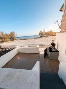 a patio with a view of the beach at Aegean Nest Beach Studios - Adults only in Monolithos