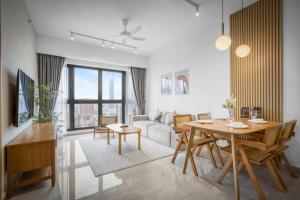 a living room with a table and a couch at Cavera Bukit Bintang in Kuala Lumpur