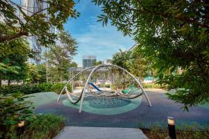 a playground in a park with a swing at Cavera Bukit Bintang in Kuala Lumpur