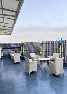 a patio with chairs and tables and a fence at Hotel Classic in Pānīpat