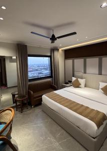 a hotel room with a large bed and a couch at Hotel Classic in Pānīpat +90 photos