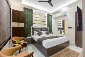 a bedroom with a bed and a table and chairs at Hotel Byland Inn- Near Connaught Place And 5 Minutes From New Delhi Station in New Delhi