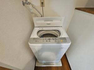 a washing machine in the corner of a bathroom at Namba Ebisu Tower701 in Osaka