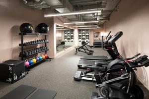 a gym with treadmills and exercise bikes at Mercure Melbourne La Trobe Street in Melbourne