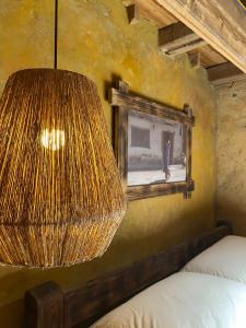 a bedroom with a lamp and a painting on the wall at SUNG Home in Dồng Văn