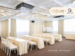 a conference room with white tables and white chairs at The Coco Journey - Eco Tent in Kelebang Besar +43 photos