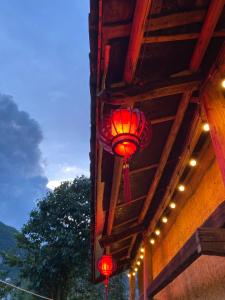 a red lantern hanging from the side of a building at SUNG Home in Dồng Văn